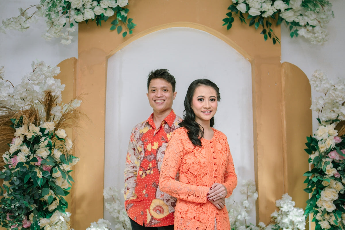 A smiling couple poses for a formal occasion.